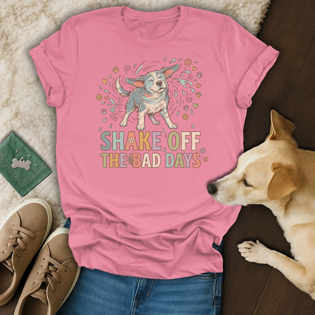 Pink t-shirt with a graphic of a dog shaking and text "SHAKE OFF THE BAD DAYS".