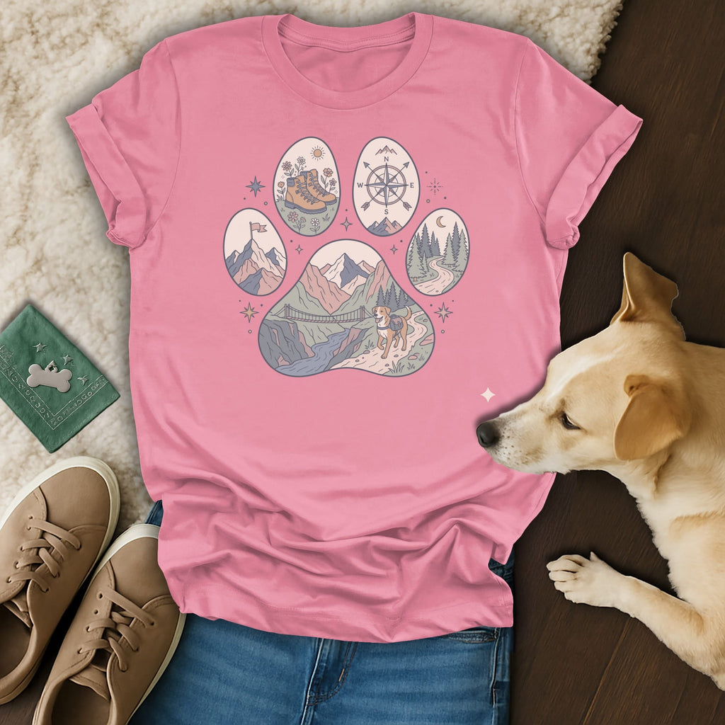 Pink t-shirt with a paw print graphic featuring mountain, bridge, dog, and compass designs.