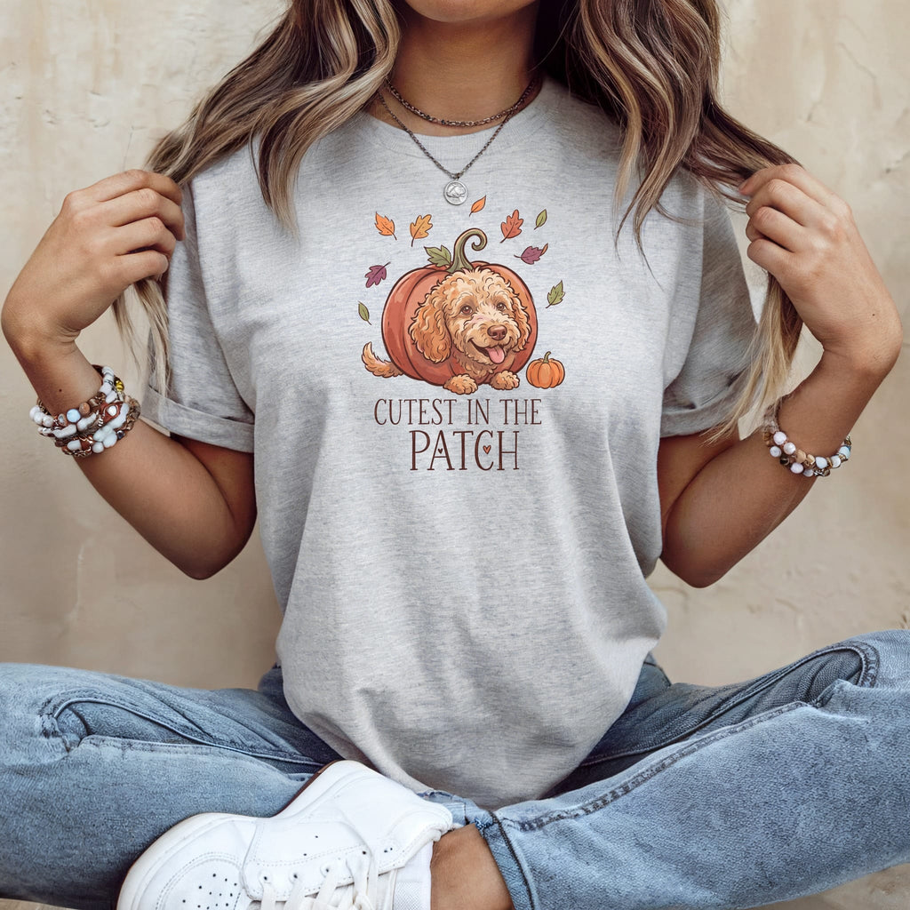 Gray t-shirt with a doodle of a dog in a pumpkin, text "Cutest in the Patch".