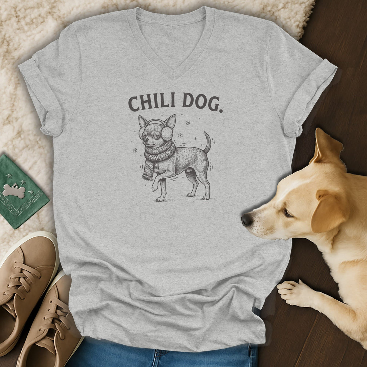 Light grey v-neck t-shirt with a "Chili Dog" graphic of a chihuahua in winter accessories.