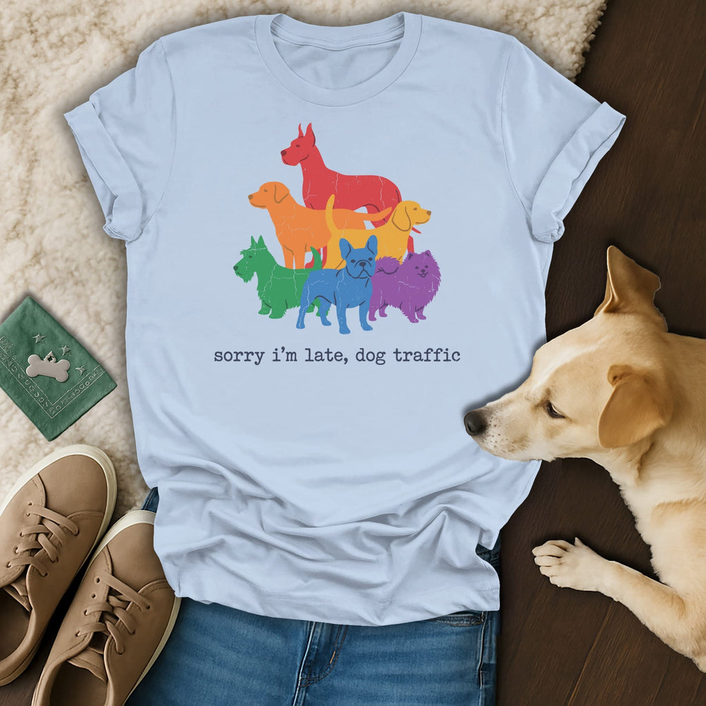 Light blue t-shirt with a graphic of rainbow-colored dogs and the text "sorry i'm late, dog traffic".
