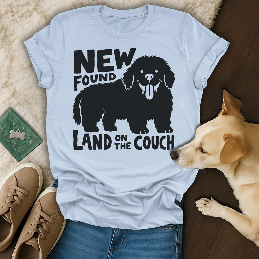 T-shirt with black graphic of a dog and text "NEW FOUND LAND ON THE COUCH".