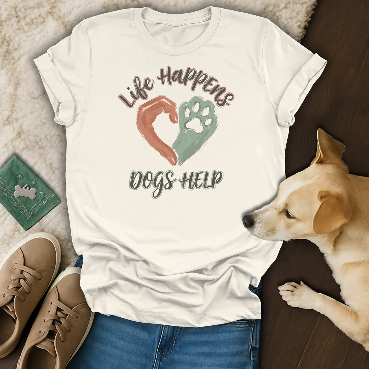 Cream t-shirt with "Life Happens Dogs Help" text, heart, and paw print graphic.