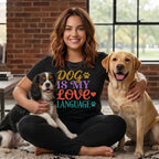 Woman wearing "Dog is my love language" shirt with two dogs.