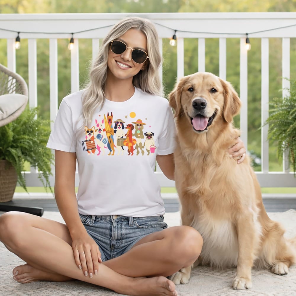 Woman with golden retriever wearing white t-shirt with illustration of dogs at the beach.