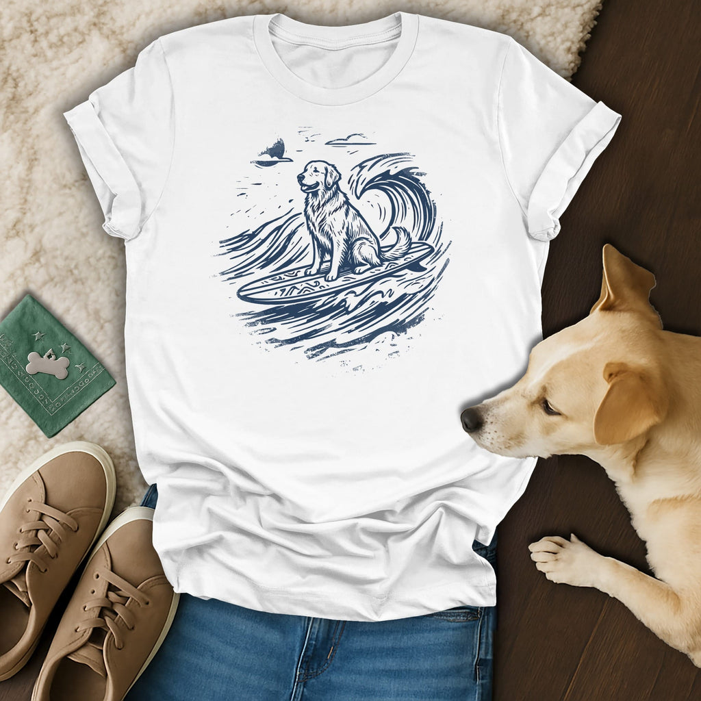 White t-shirt with a blue graphic of a golden retriever surfing a wave.