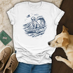 White t-shirt with a blue graphic of a golden retriever surfing a wave.