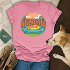 Pink t-shirt with cartoon dog in inflatable pool graphic.
