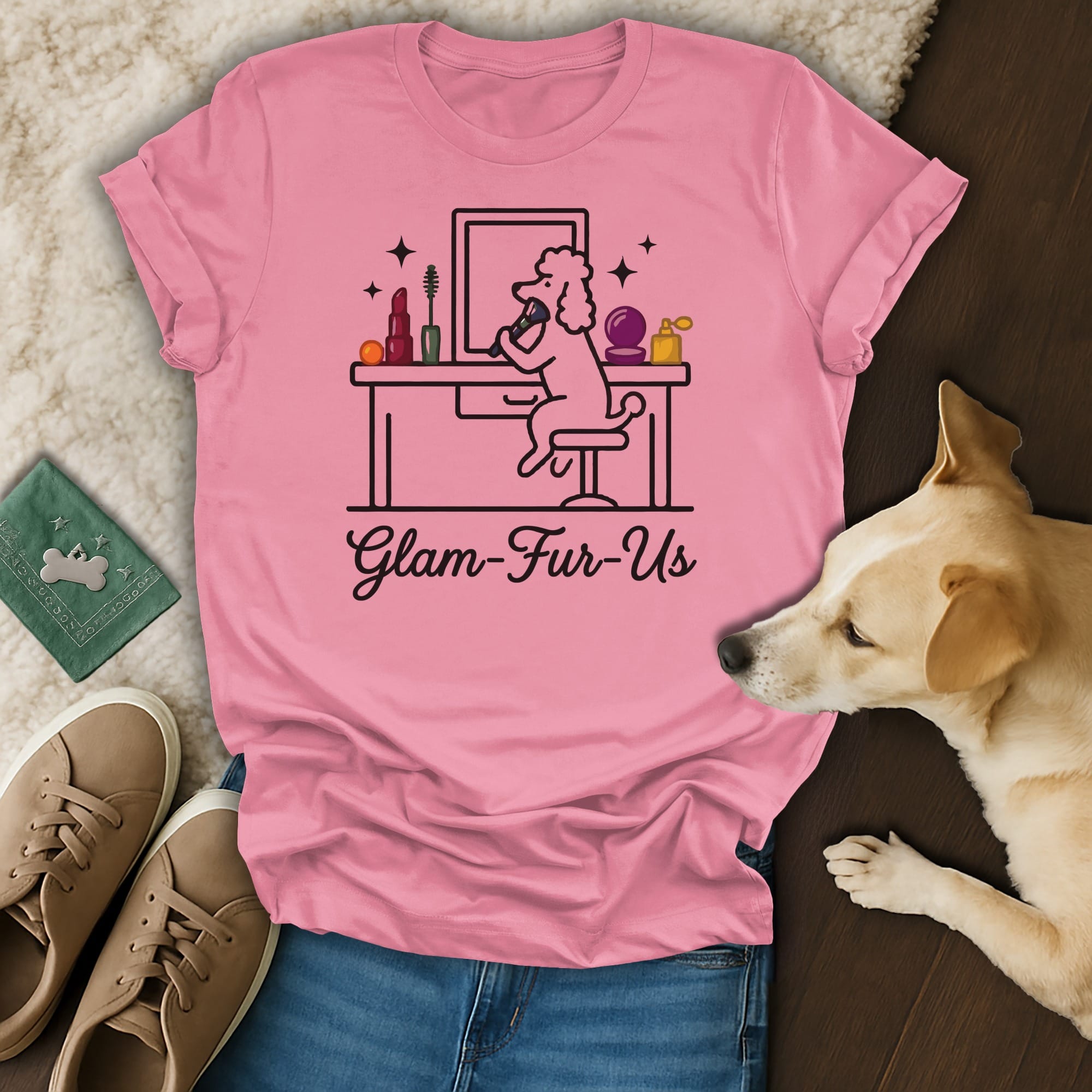 Pink t-shirt with a line drawing of a poodle doing makeup, "Glam-Fur-Us" text.