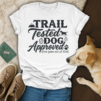 White t-shirt with "Trail Tested Dog Approved" text and dog paw print.