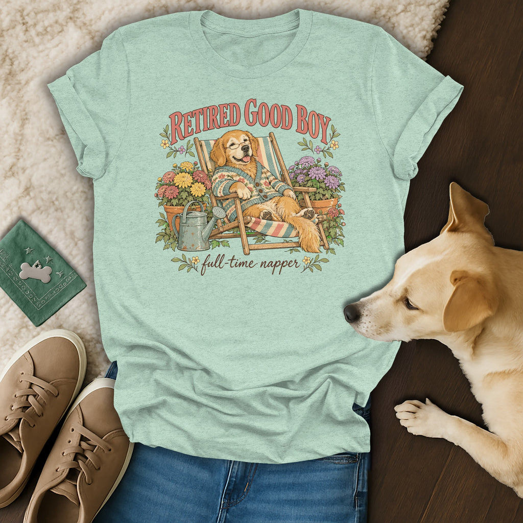 Light green t-shirt with a vintage graphic of a golden retriever relaxing in a deck chair, surrounded by flowers.