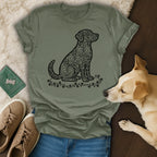 Green t-shirt with a black outline of a dog filled with heart shapes.