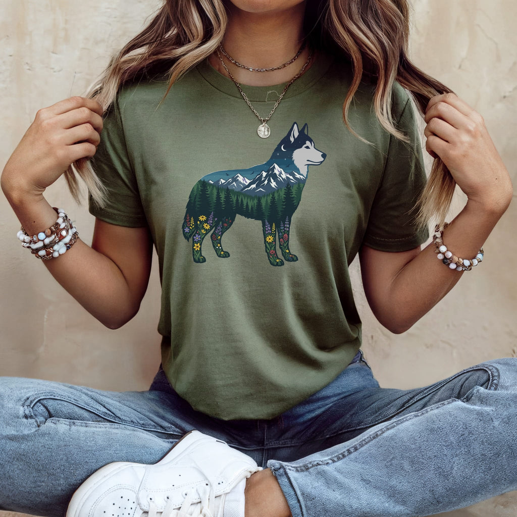Green t-shirt with a husky silhouette filled with a mountain landscape and flowers.
