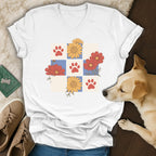 White t-shirt with a tiled pattern of paw prints and flowers.