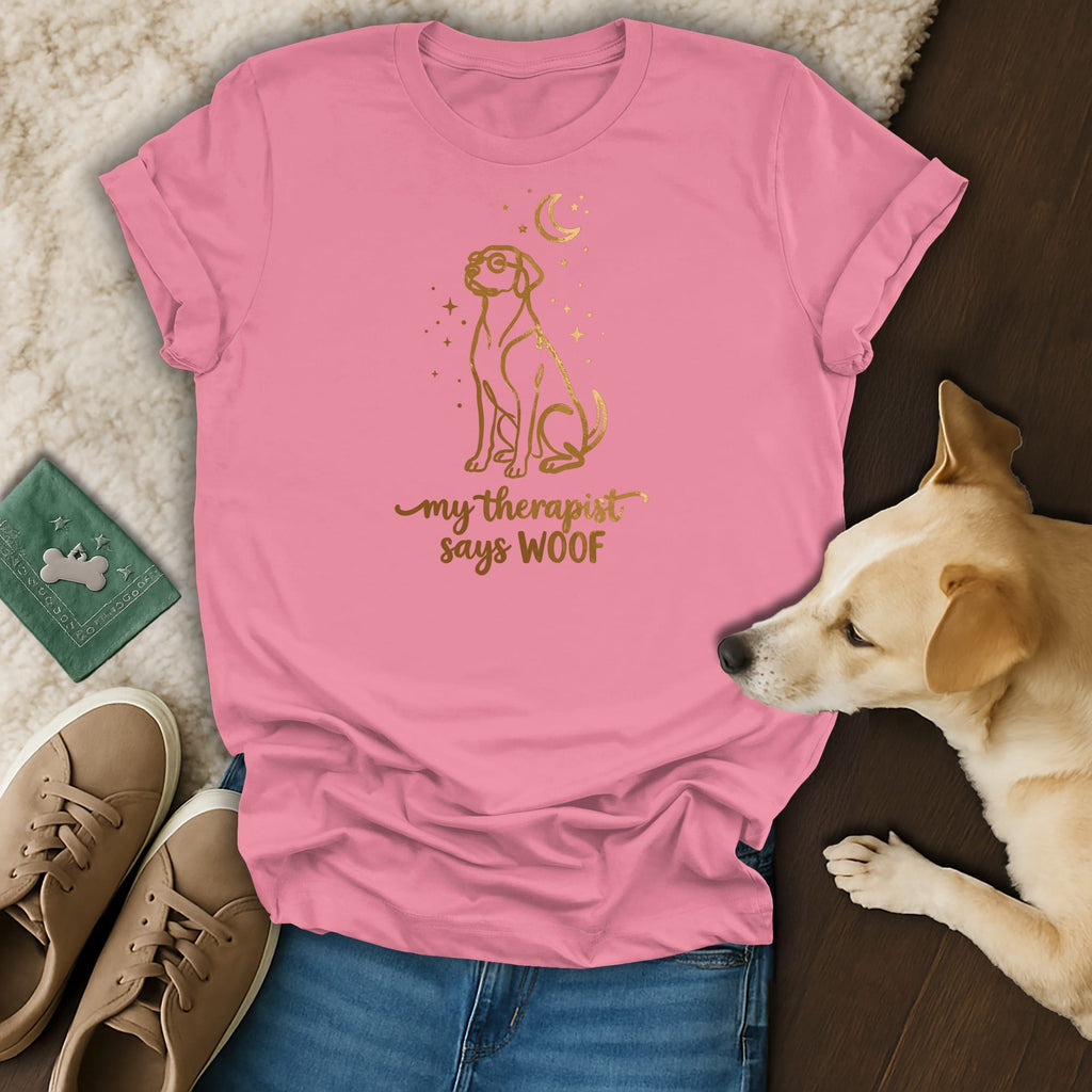 Pink t-shirt with gold graphic of a dog and text that says "my therapist says WOOF".