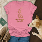 Pink t-shirt with gold graphic of a dog and text that says "my therapist says WOOF".