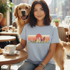 Woman with Golden Retriever wearing a t-shirt with cartoon dogs.