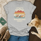 Grey t-shirt with retro graphic "This Is My Dog Walking Shirt" and multiple dogs on leashes.