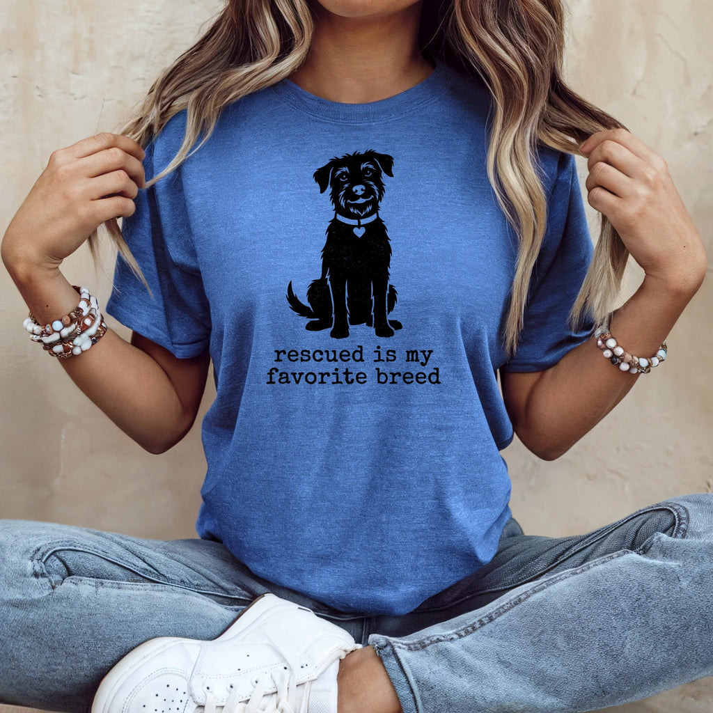 Blue t-shirt with black dog silhouette and text "rescued is my favorite breed".