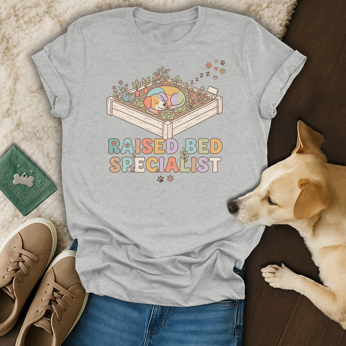 Grey t-shirt with a dog sleeping in a garden bed, reads "Raised Bed Specialist."