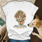 A white v-neck t-shirt featuring a graphic of a dog in a birdhouse with flowers and the text Home is where the dog is.