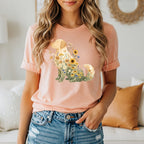 Peach t-shirt with a golden retriever dog filled with flowers and butterflies.