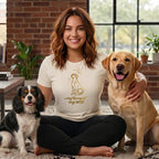 Woman with two dogs, wearing a cream t-shirt with gold dog and text design.