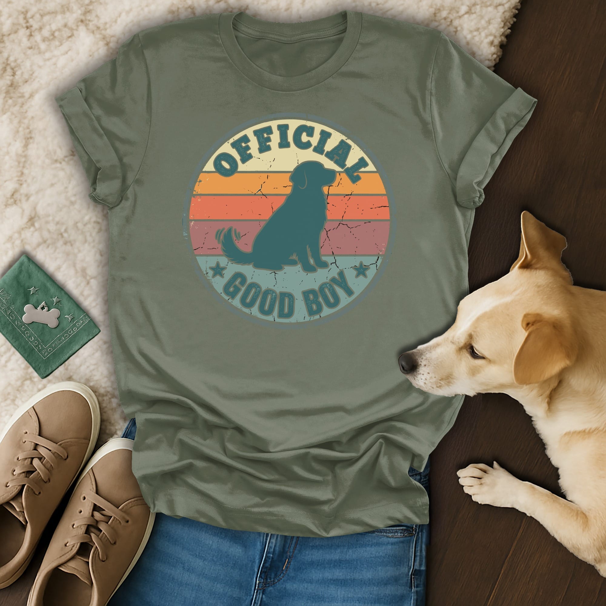 Olive green t-shirt with "Official Good Boy" text and dog silhouette on a vintage sunset background.