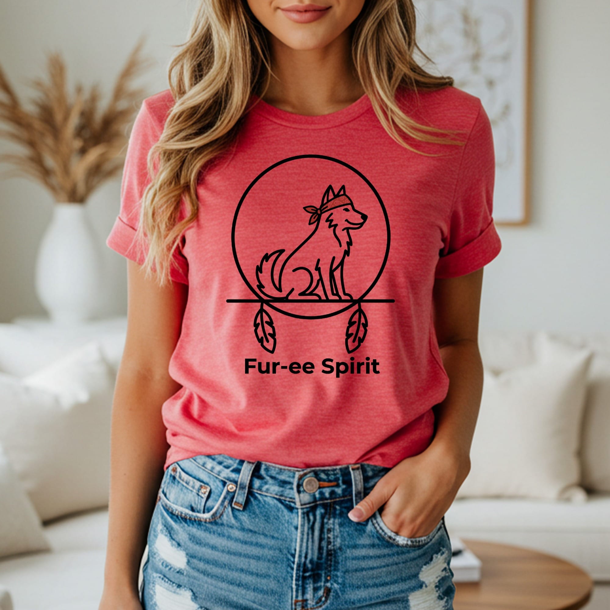 Salmon pink t-shirt with a circular line drawing of a wolf and feathers.