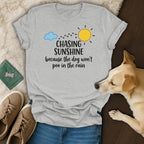 Gray t-shirt with "Chasing Sunshine because the dog won't poo in the rain" text.