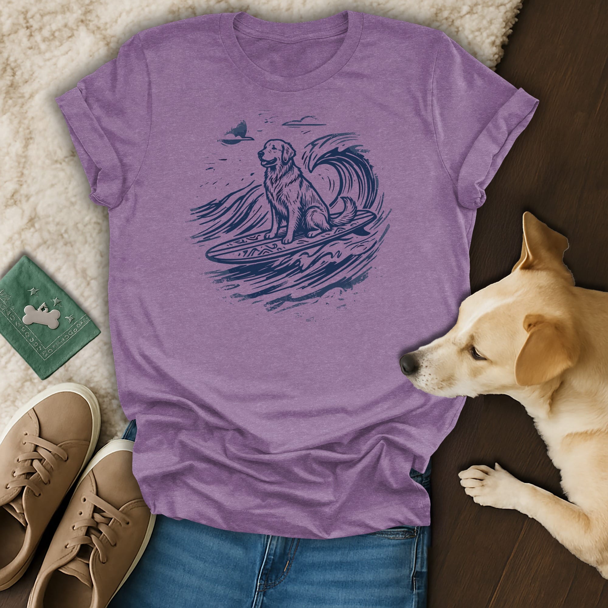 Golden retriever surfing on a wave, depicted in a graphic t-shirt.