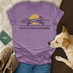 Purple t-shirt with graphic of running dog and text "Runnin' on Treats and Adrenaline".