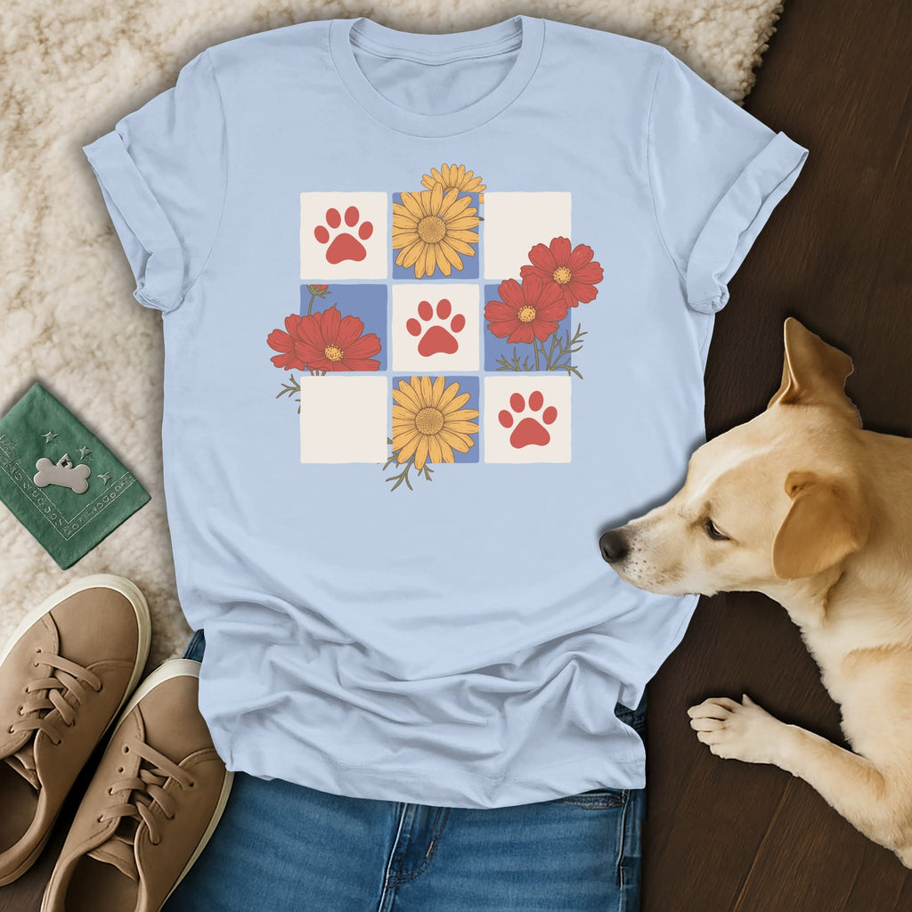 Light blue t-shirt with paw prints and floral pattern on a grid.