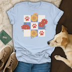 Light blue t-shirt with paw prints and floral pattern on a grid.