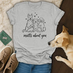 Grey t-shirt with line drawing of five dogs and the text "mutts about you".