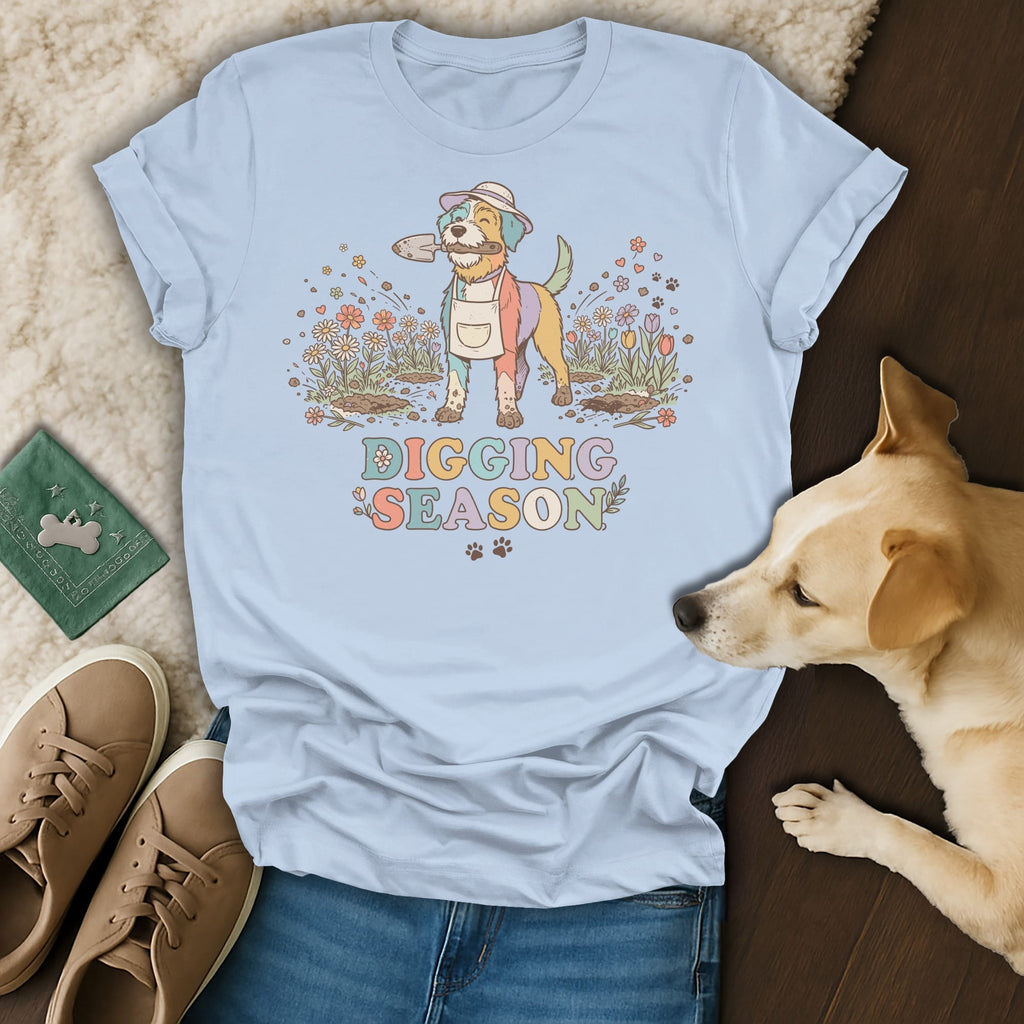 Light blue t-shirt with colorful dog wearing apron and hat holding shovel, "Digging Season" text.