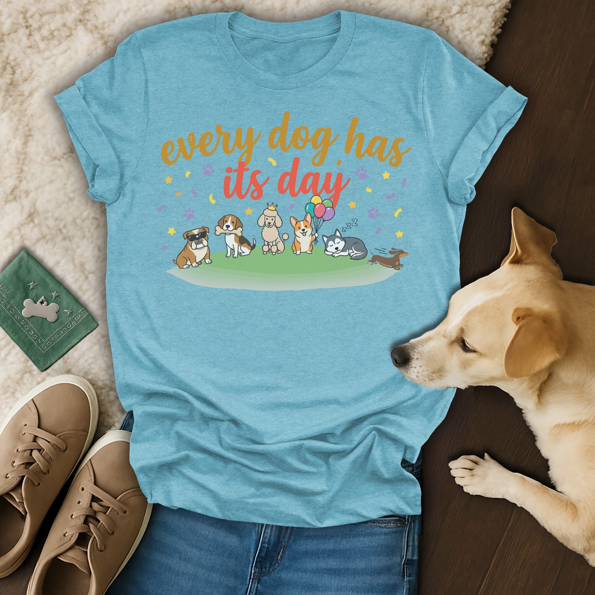 Light blue t-shirt with cartoon dogs and "every dog has its day" text.