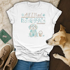 White t-shirt with graphic of a dog saying "All I Need Is The Beach".