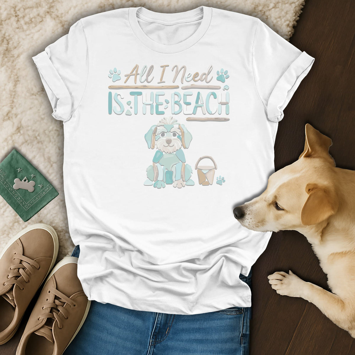White t-shirt with graphic of a dog saying "All I Need Is The Beach".