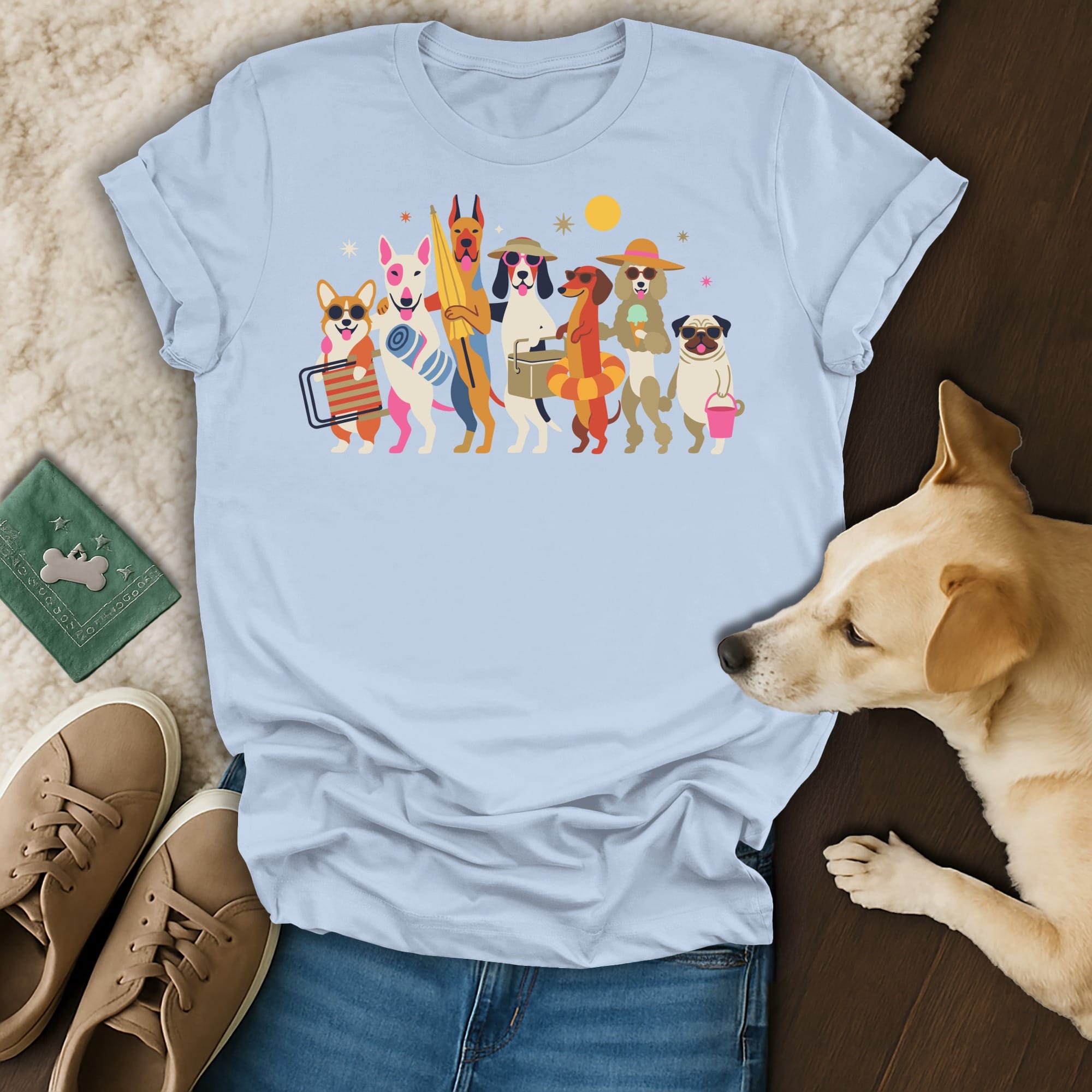 Light blue t-shirt with cartoon dogs dressed for summer vacation.