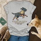 T-shirt with running dog design featuring American flag and "Brave and Free America's 250th 1776-2026" text.