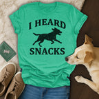 Teal t-shirt with black text "I HEARD SNACKS" and silhouette of dog.