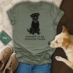 Olive green t-shirt with a black dog silhouette and "Rescued is my favorite breed" text.