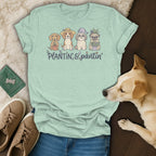 Light green t-shirt with four dogs, plants, and the text "PLANTIN' & pantin'".