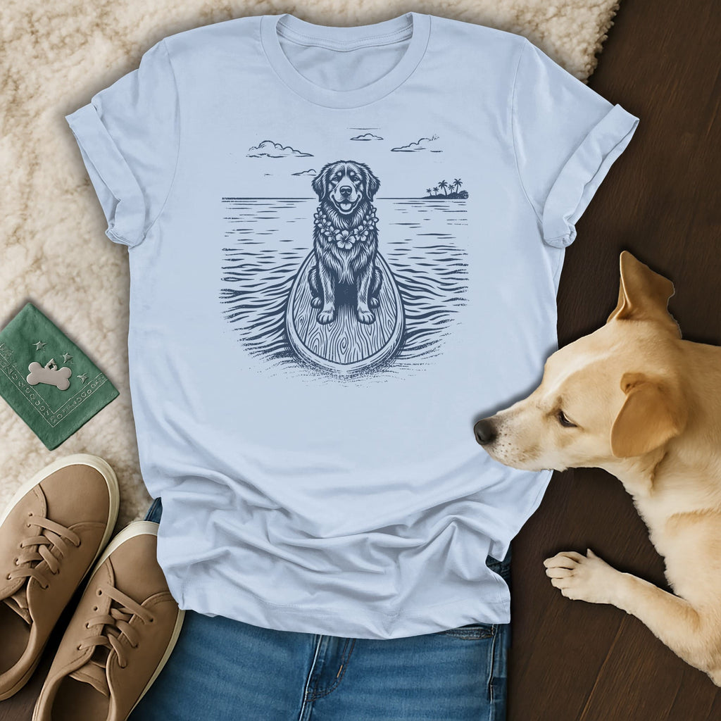 Graphic t-shirt with a dog on a surfboard, ocean, and palm trees.