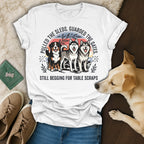 White t-shirt with three huskies and text: "Pulled the sleds. Guarded the gates. Still begging for table scraps."