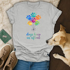 Grey t-shirt with colorful paw print balloons and text "dogs keep us afloat".