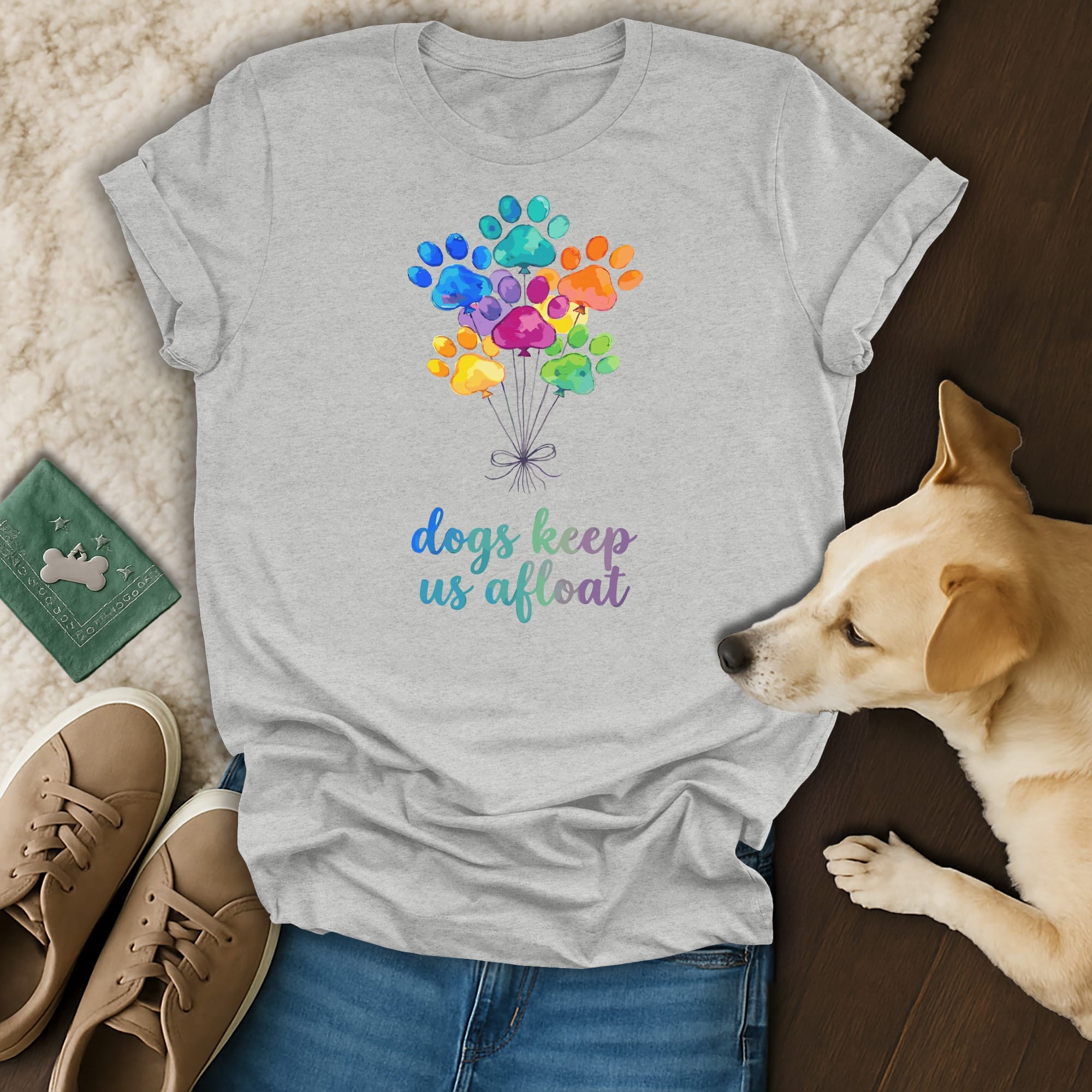 Grey t-shirt with colorful paw print balloons and text "dogs keep us afloat".