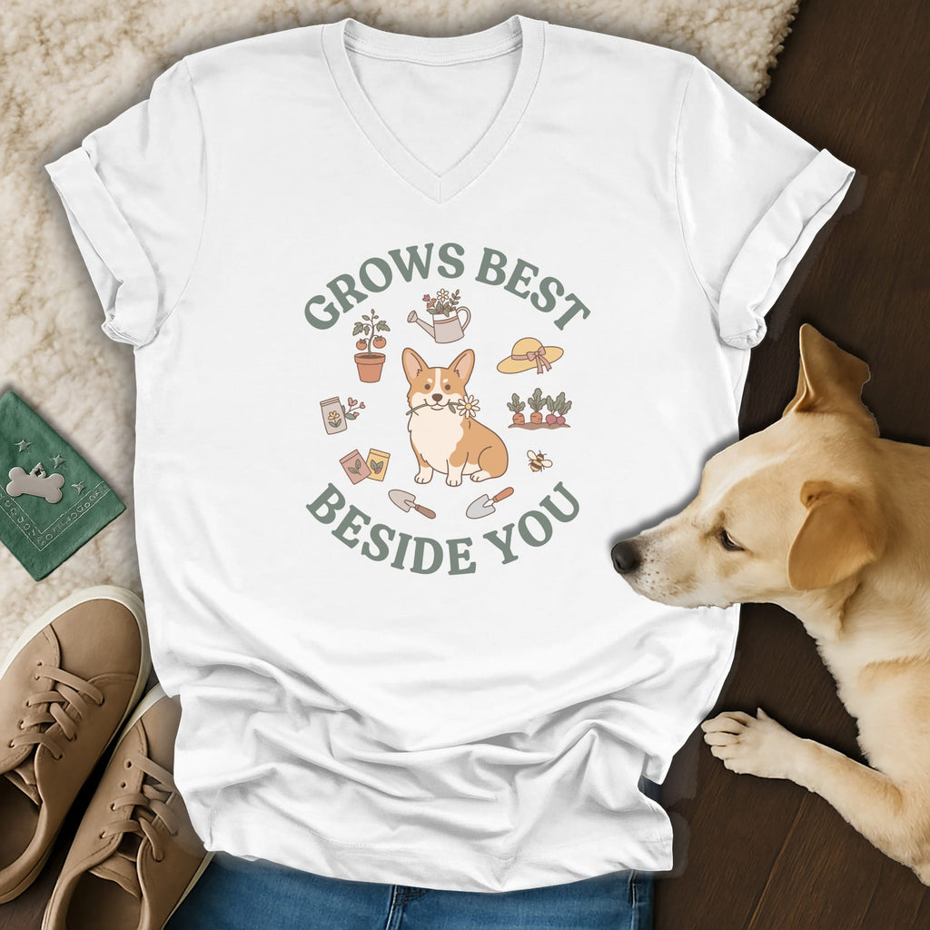 A white V-neck t-shirt featuring a corgi and garden graphic with the text Grows Best Beside You.