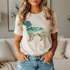 Cream t-shirt with a dog silhouette filled with ocean waves and seashells.